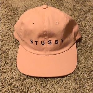Pink Stussy baseball cap.